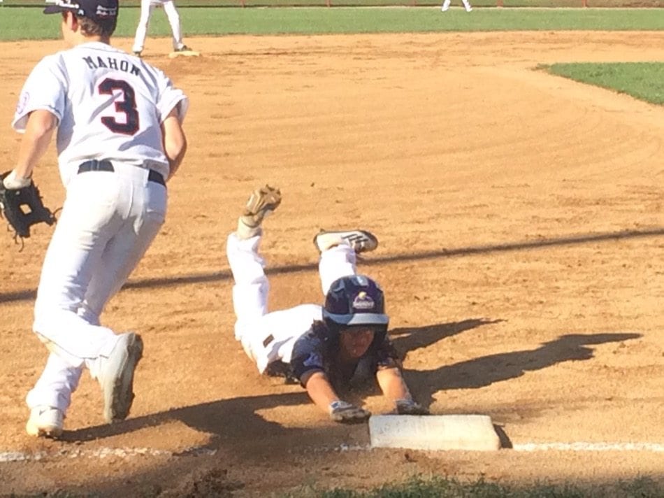 Pear City’s Jayton Pang slides into third in the first inning. Pang would score to start the 11-0 rout.